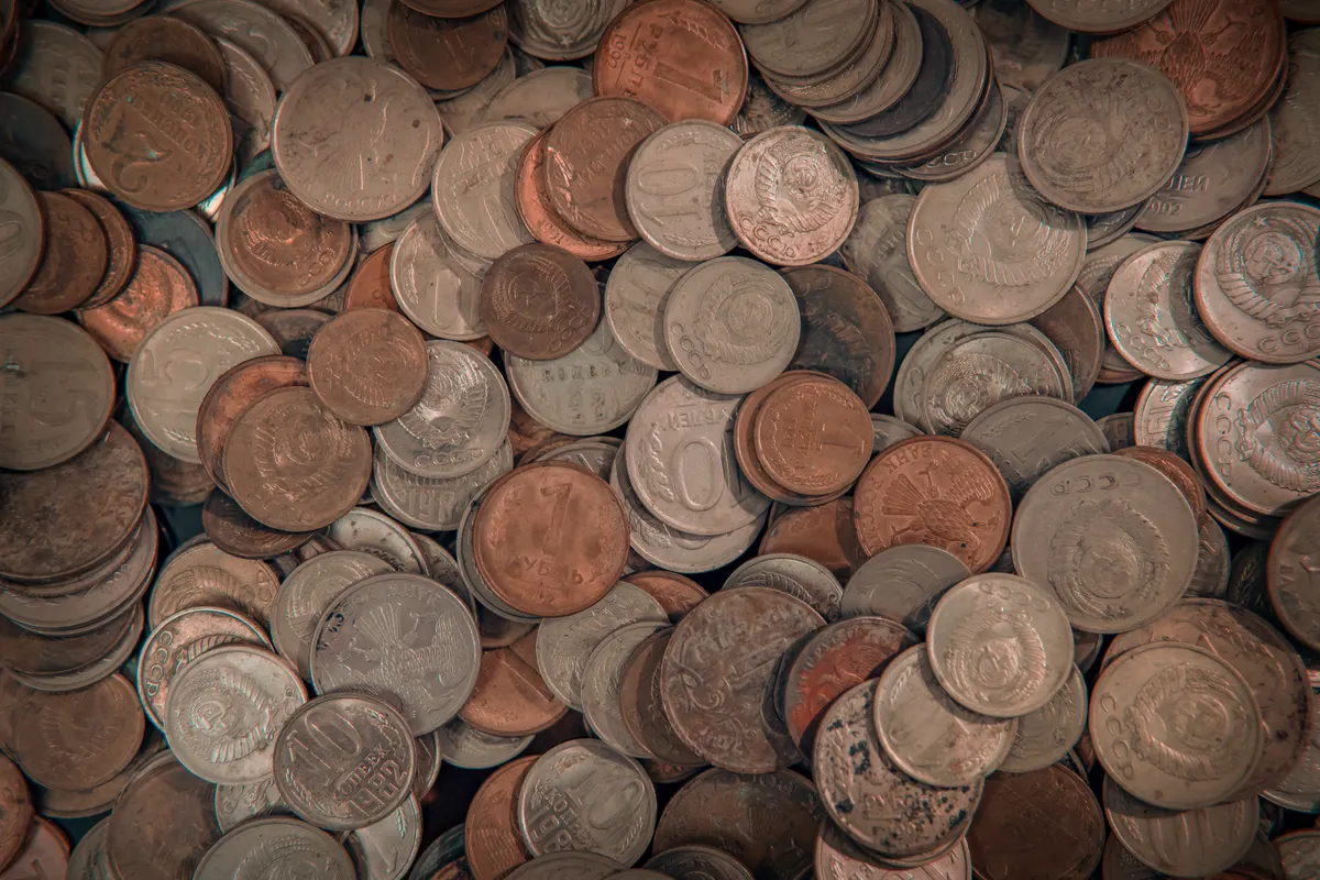 A diverse assortment of international coins spread out for identification and numismatic study.