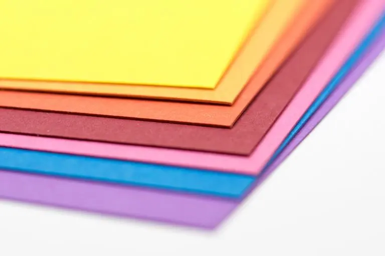 Colorful stack of square kami paper prepared for beginner origami projects.