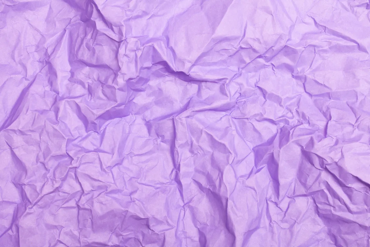 Comparing different sheets of specialty wet fold paper for origami durability and texture.