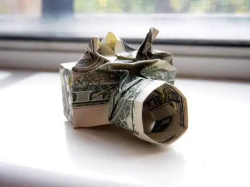 Several dollar bills folded into rings and hearts displaying the durability of currency paper.