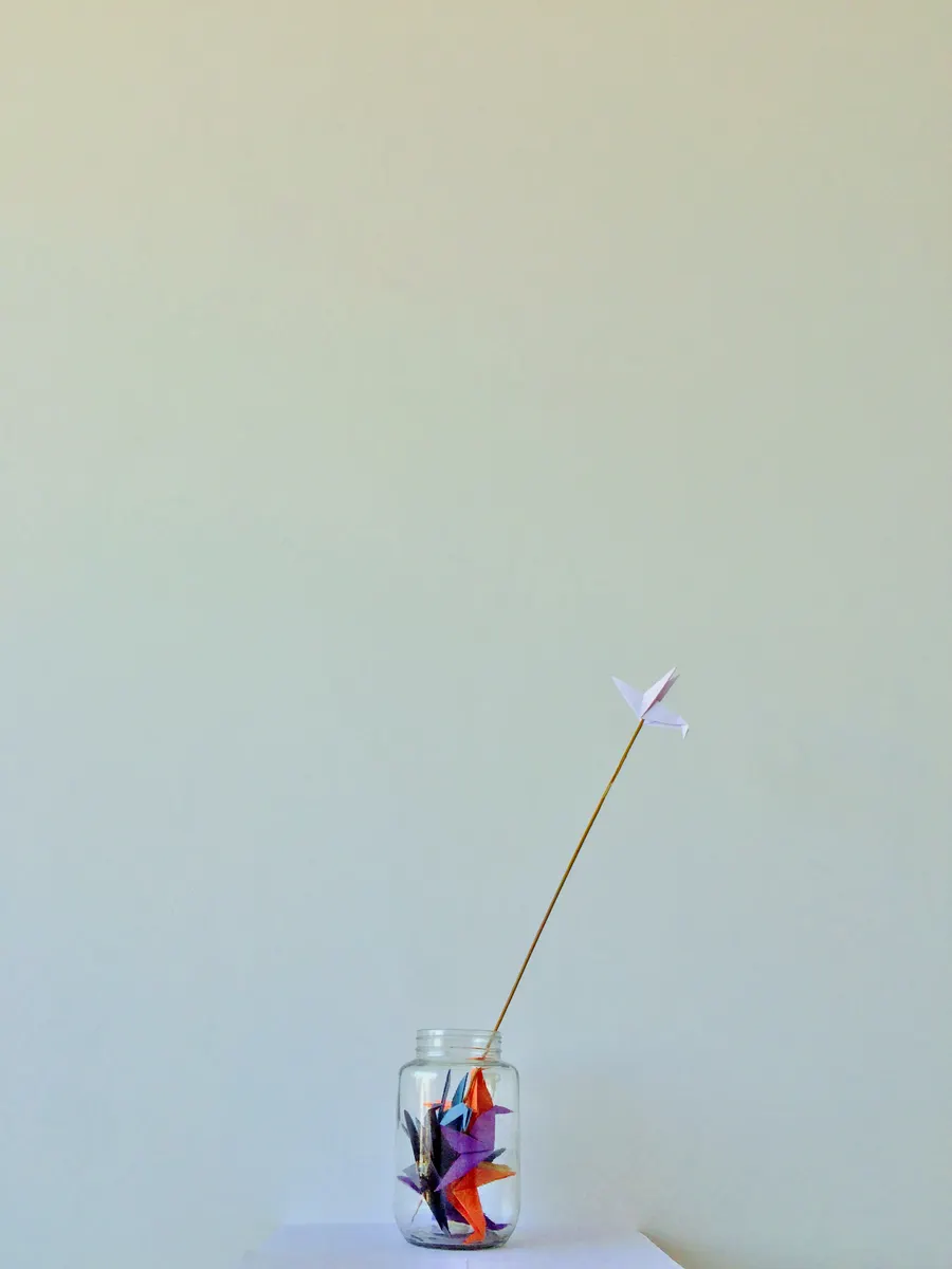 A paper crane model demonstrating common mistakes during folding practice.