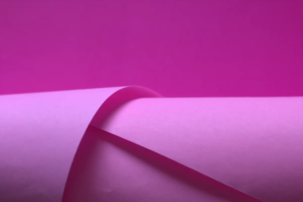 Close-up of a gradual curved fold being pressed lightly on heavy paper