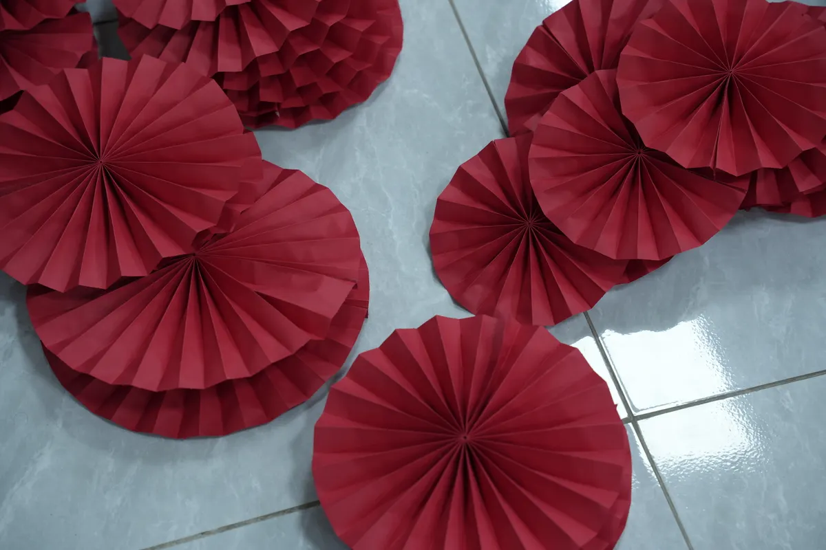 A batch of matching modular origami units laid out neatly before final assembly.
