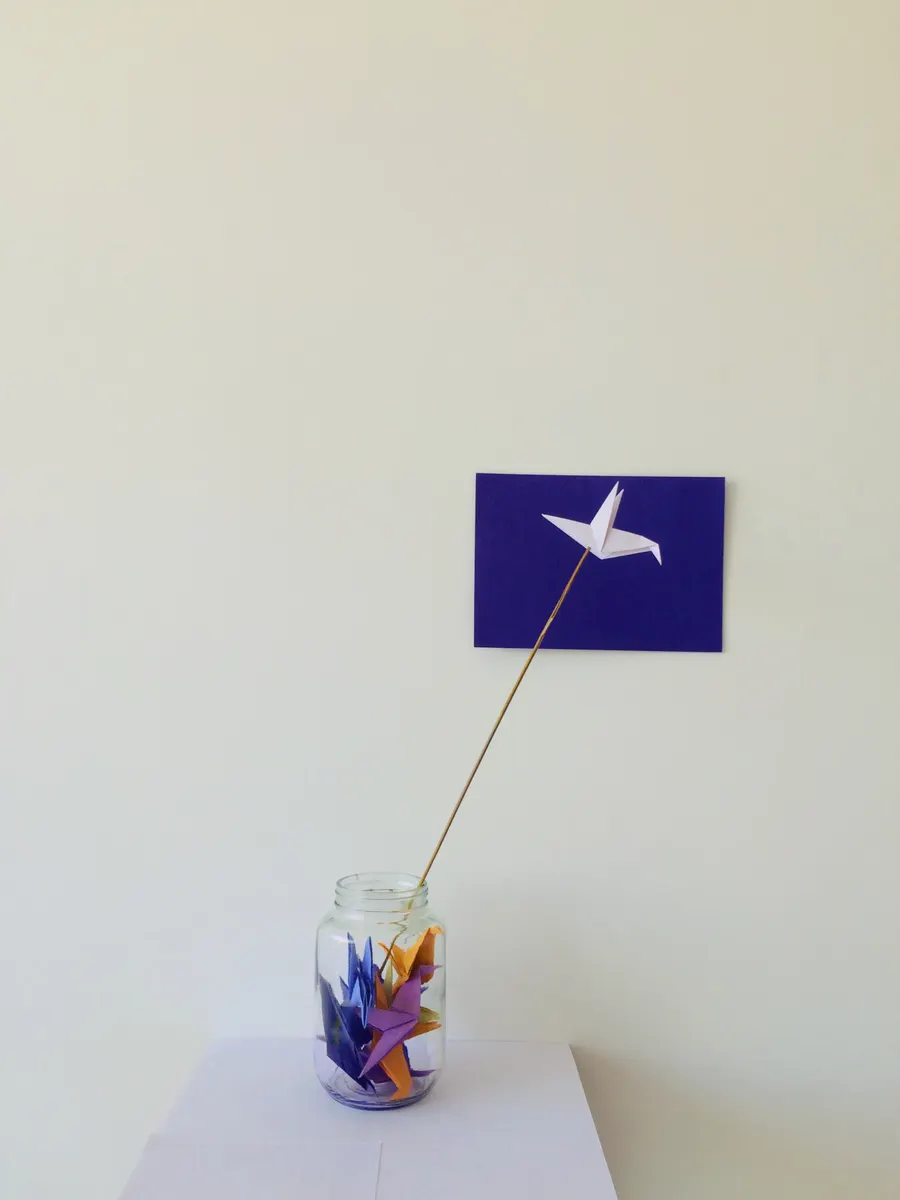 An origami crane head and beak formed using a precise inside reverse fold technique.