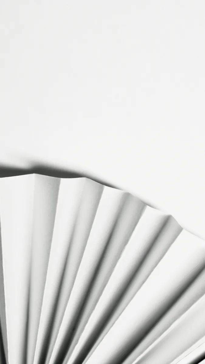 Close-up of precise cuts and crisp fold lines on a white paper sheet in an origami sekkei design.