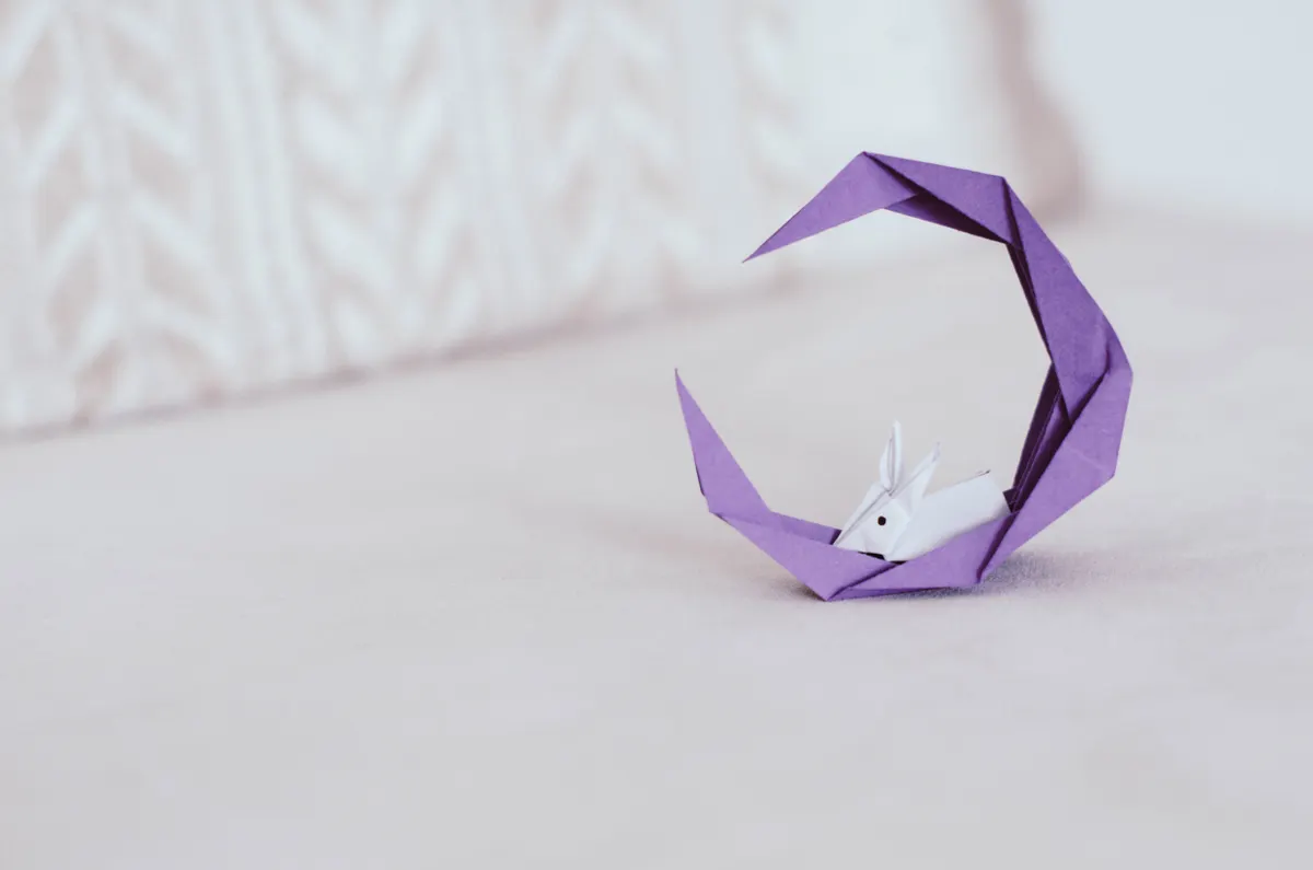 A neatly arranged origami starter kit featuring colored kami paper and basic folding supplies on a clean table.