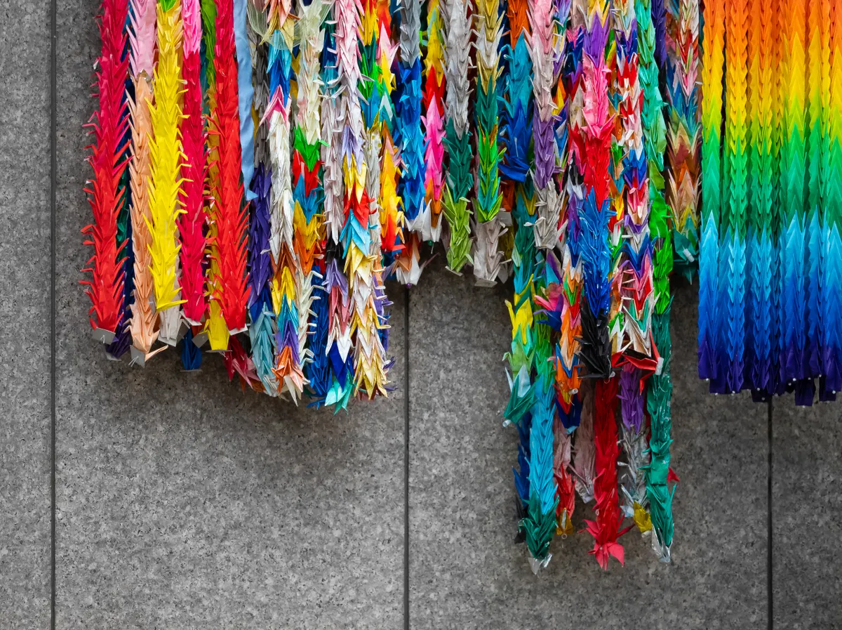 A colorful display of various origami figures and traditional paper folding crafts from around the world.
