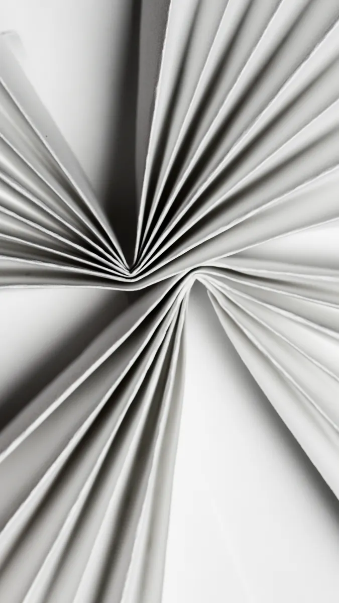 Detailed view of paper being folded using a petal fold and reverse fold technique.