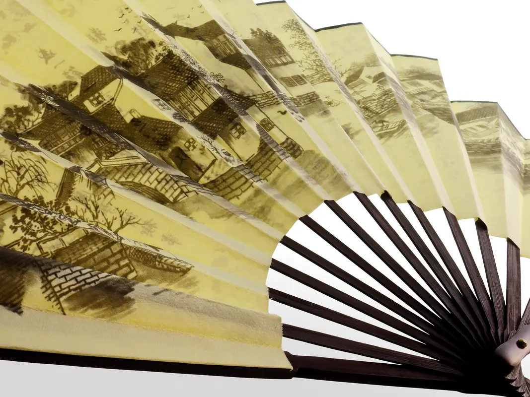 An accordion-style paper fan showing alternating mountain and valley folds in a practice sequence.