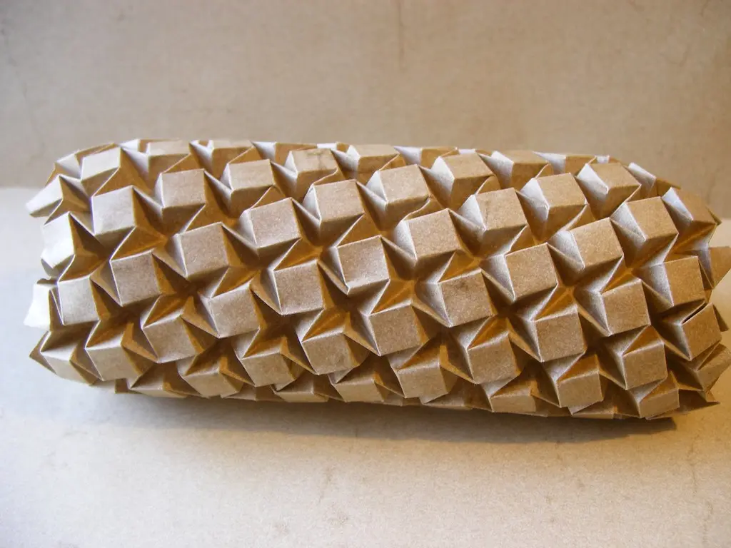 A detailed comparison showing a geometric paper tessellation next to a locked modular origami star.