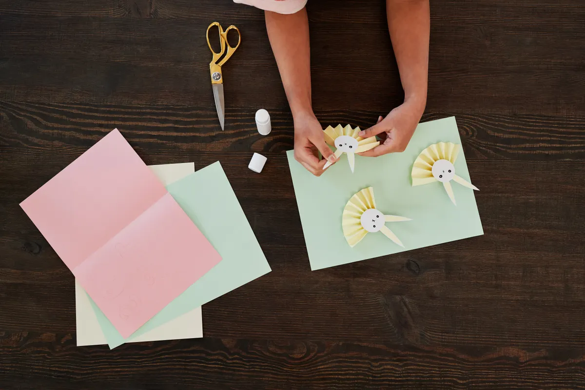 Side-by-side comparison showing traditional folded paper models next to cut paper kirigami designs.