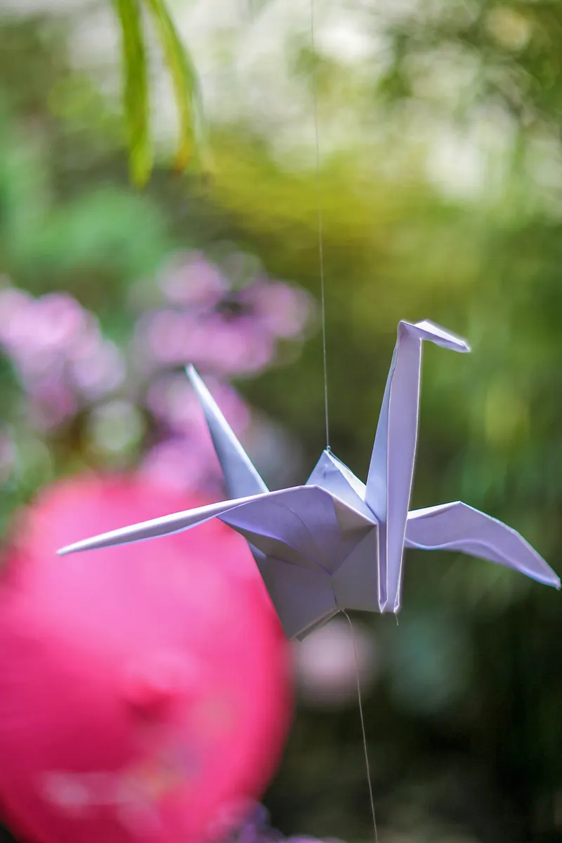 A finished traditional paper crane displaying sharp wings and a delicate beak.