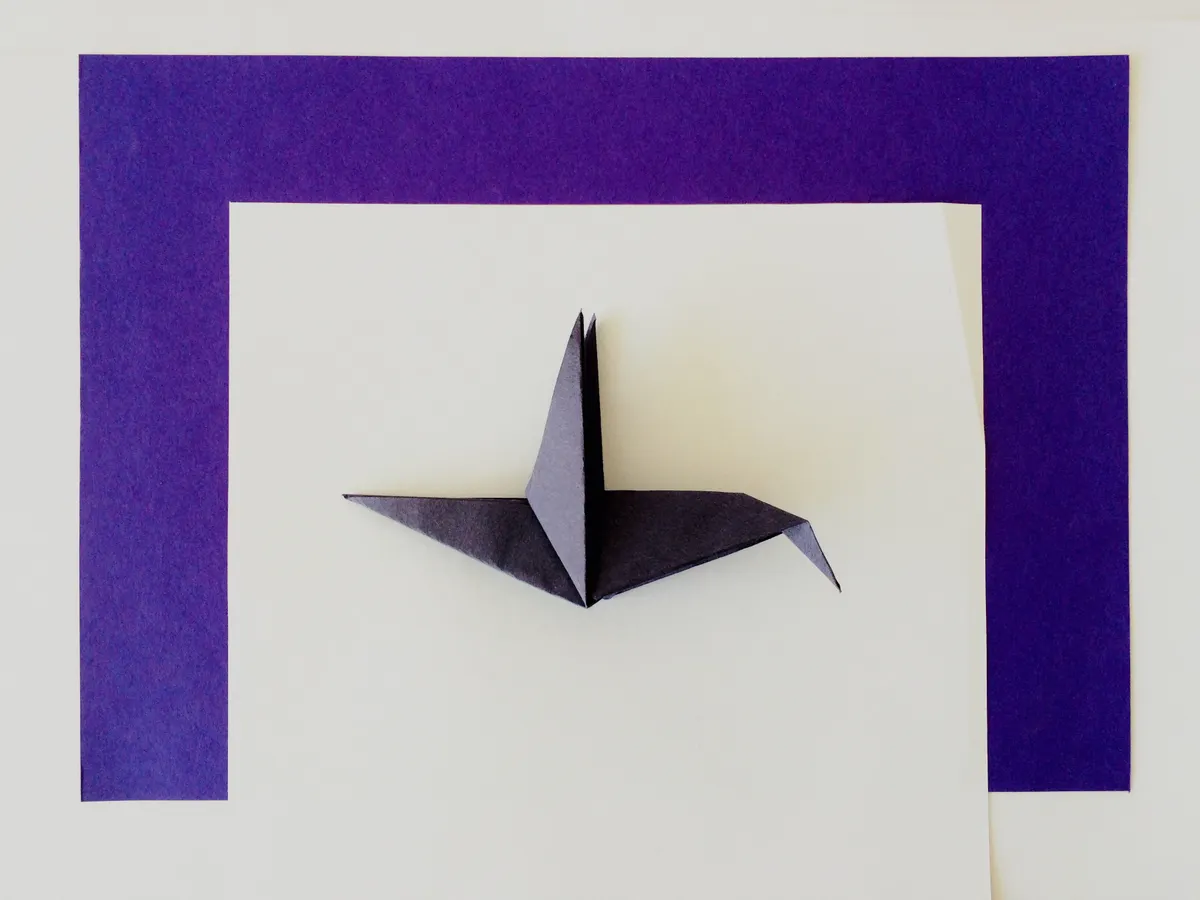 An asymmetrical origami paper model showing alignment issues on one side.